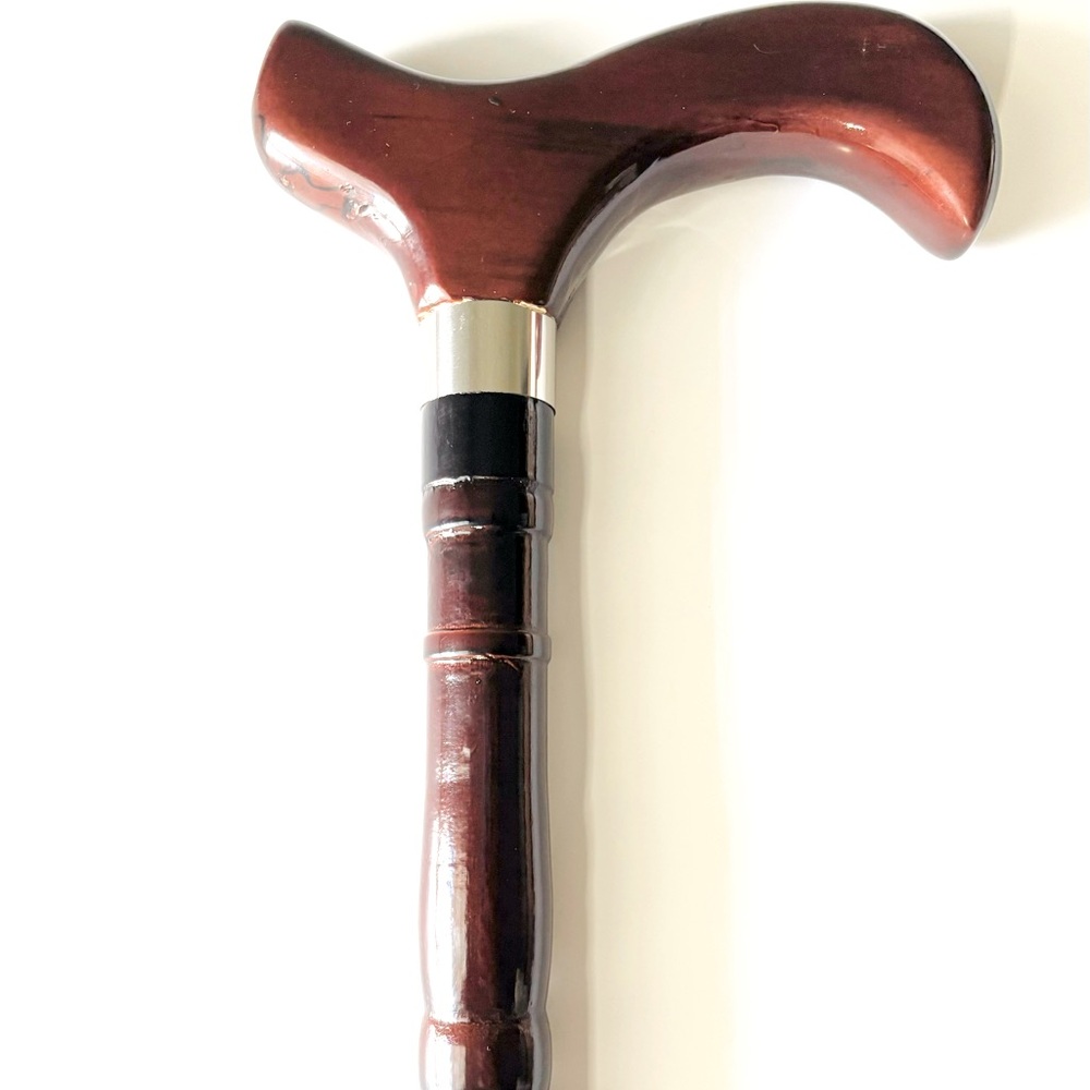 Wooden cane with small imperfections around handle (E)